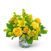 Yellow roses and lilies in a clear glass vase