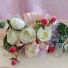 Creamy white roses clustered into a petite wrist corsage make a timeless
