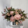 Pink chrysanthemum bouquet in a white hat box