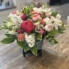 Mixed pink and white bouquet in a black container