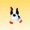 Black-and-white plush dog with red polka-dot ears and paws