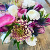 Bouquet of pink, white, and purple flowers with spiky blue accents