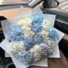Bouquet of blue and white hydrangeas wrapped in white paper