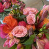 Bouquets of pink, orange, and coral roses with mixed blooms