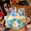 Blue and white rose bouquet with soccer player toppers and butterfly accents