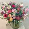 Mixed pink and white floral arrangement in a ribbed glass vase