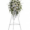 The elegant spray includes white roses, white Asiatic lilies and white carnations