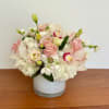 Pink and white floral arrangement in a white vase