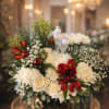Soft ivory roses and lush chrysanthemums form a low, elegant centerpiece perfect