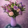 Lilac and blush roses pair with tall pink snapdragon spikes to create