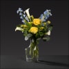 Uniquely shaped vase filled with delphinium, roses, miniature calla lilies, veronica, and
