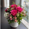 A lush, romantic arrangement featuring vibrant hot pink roses surrounded by soft
