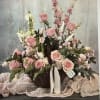 A graceful and sophisticated arrangement designed in soft blush and pastel tones