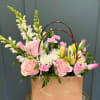 This spring time arrangement in a perfect floral tote will brighten anyones