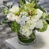 A beautiful floral arrangement in a clear glass vase, styled in a