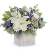 White lilies and purple flowers arranged in a square box