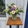 Assorted spring garden flowers arranged in a contemporary vase