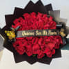Bouquet of red roses wrapped in black paper with a ribbon