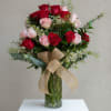 A lush mix of saturated red and blush-pink roses creates a classic