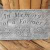 "In loving memory of a Farmer" cement stone with a stand 