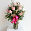 Soft pink roses gathered in a loose, airy cluster give this flower