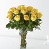 Yellow roses arranged in a clear glass vase