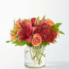 Capturing the vibrant colors of autumn foliage, this eye-catching arrangement is an