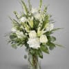 White roses and lilies in a clear glass vase