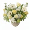 A soft and elegant arrangement includes soft yellow and white roses, 