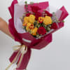 A vibrant bouquet featuring a dozen roses paired with fresh tulips and