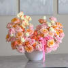 A lush, rounded arrangement in soft blush, peach, cream and pale orange-perfect