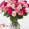 A lush cluster of pink, blush, and white roses creates an instantly