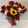 Bouquet of red and white roses with a sunflower in a glass vase