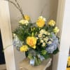 Sunlit yellow roses headline this airy flower arrangement, the perfect birthday bouquet