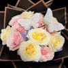 this stunning bouquet blends soft pastel roses with delicate butterfly detail, creating
