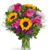 Bright sunflowers and vivid pink roses make a joyful statement in this