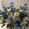 Bouquet of white roses and blue flowers with butterfly accents