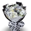 White daisies, lush white hydrangea clusters, and elegant lily blooms are arranged
