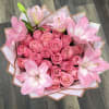Pink rose bouquet with large pink lilies wrapped in white and tan paper