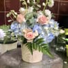 This charming arrangement is a soft, garden-style bouquet that balances the classic