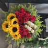A bold red-and-gold contrast greets the recipient: clustered red roses paired with