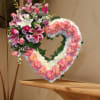 Heart-shaped floral wreath with pink roses and lilies