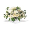 A stylish bubble bowl filled to the brim with white roses and
