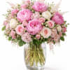 A lush cascade of pink peonies and blush-to-ivory roses makes this flower