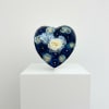 A lush cluster of deep blue, pale blue, and white roses sits
