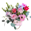Soft pale pink roses and a single pink gerbera daisy create the