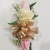Pink and white calla lily corsage with gold ribbon