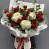 Bouquet of red roses and white hydrangeas wrapped in white paper