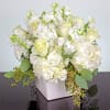 White roses and hydrangeas in a square white vase