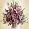 Large bouquet of pink lilies and mixed flowers in a woven basket